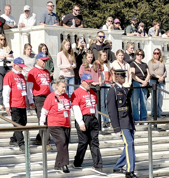 DELWIN LARUE, who is on the front row by the right side of the Sentinel, walks down the flight of stairs to the front of The Tomb of the Unknown Soldier during the wreath ceremony at Arlington Cemetery.