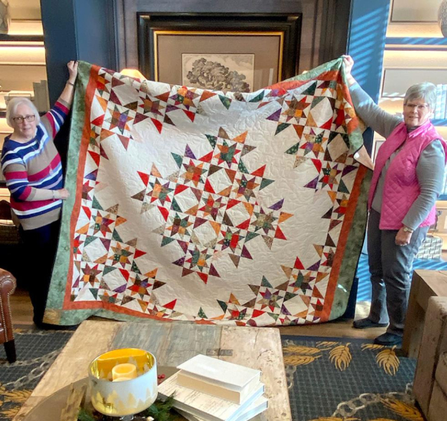 THE LUCKY WINNER of the beautiful Crossroads Quilt Guild quilt was Mary Roe, left, a childhood friend of Joyce Schmitz, right. The quilt was hand delivered to Mary via her friend, Joyce Schmitz, right.