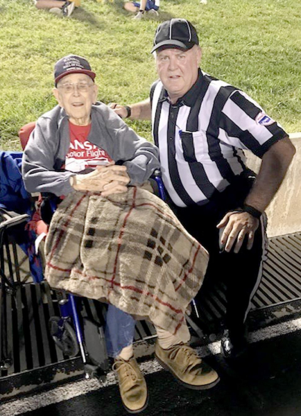 EUGENE WILTFONG OF NORTON, left, was able to watch his son, Doug, officiate a football game at Norton last fall. Wiltfong, a native of Norton, credits his dad as being a big influence on his pursuing officiating. The elder Wiltfong was a former official, himself, and also athletic director of Norton schools.
