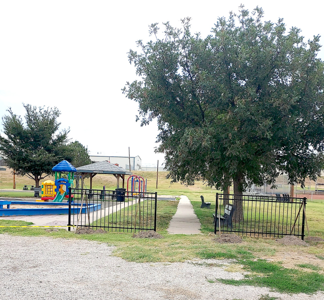 NEW POWDER-PAINTED WROUGHT IRON FENCING is being installed at the Stockton City Park. The fence will go where the blue posts and wooden fencing had previously marked the road to the playground. A gate by the ball field and playground will be a new addition. The funds for the project are from a Heartland Community Foundation grant with SB Construction receiving the bid. Jason Lindsey is the subcontractor for the project.