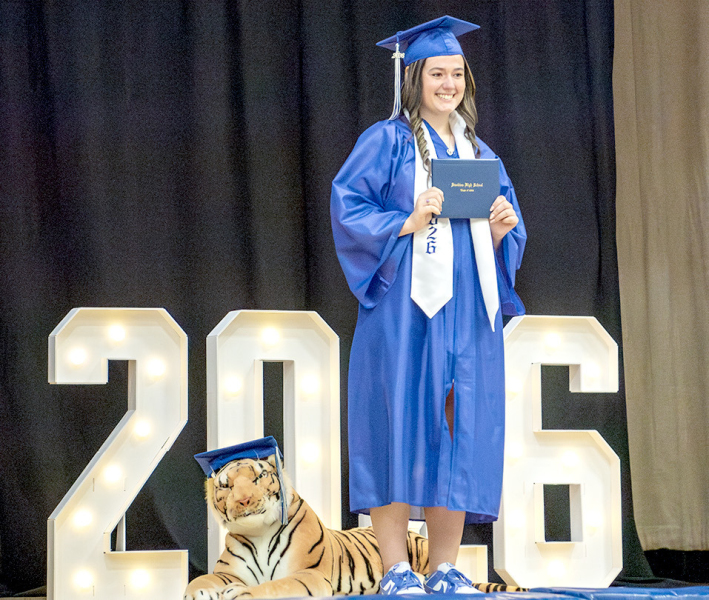 Stockton High School graduate Cailee Miller proudly shows off her diploma