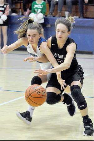 TATUM HAMILTON (LEFT) AND AUBREY DEWEY chase after a loose ball in the Lady Tigers’ win over Plainville last Friday.