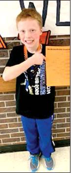 ZEKE BALTHAZOR proudly shows off his bracket after he was crowned champion in his weight class at the Ellis Open on Saturday, January 18th.
