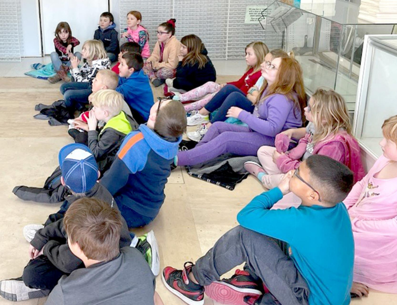 THIRD GRADERS from Stockton Grade School listen to a presentation about informational writing from Susan Schneider during a visit to the Stockton Sentinel last Thursday.