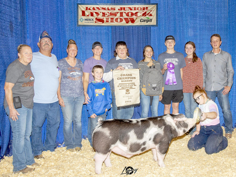 RYAN MONGEAU had a good contigent of family and friends present during the Kansas Junior Livestock Show held October 1-3. Mongeau won the Grand Champion Market Hog Title with his Dark AOB. Pictured left to right include: Janice Hammond, Zeke Hammond, Michelle Stithem, Dawn Mongeau, Eli Atkisson (in front of Dawn), Ryan Mongeau, Bodye Stithem, Tucker Goss, Noah Goss, and Judge Nathan Peters.