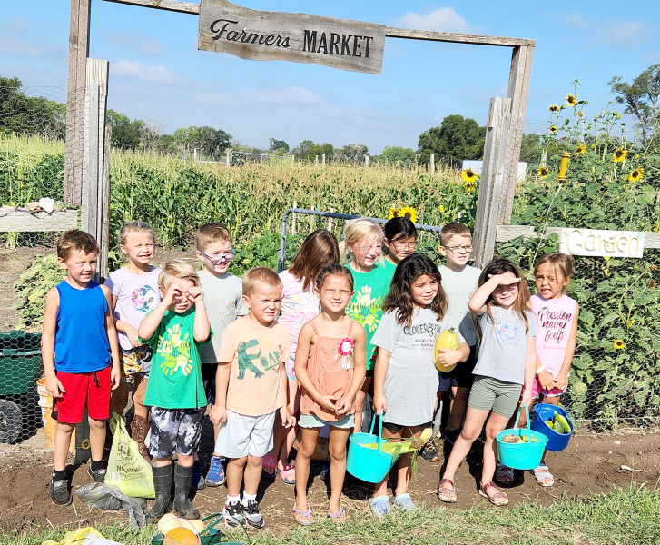 THE CLOVERBUDS 4-H GROUP, founded in 2024, visited Miss Janie’s garden and orchard on August 24, 2024, where they enjoyed many activities involving garden produce. Kids attending included back row, from left: Owen Inglsbee, Brynlie Kreutzer, Jasper Miller, Addison Becker, Waylynn Bigges, Hallie Gallaway, and Jax Miller. Front row, from left: Weston Biggs, Connor Look, Quinlee Hickman, Kamayah Gallaway, Raylyn Swaney, and Bella Heller.