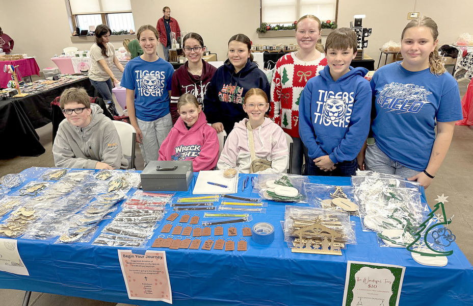 HOLIDAY MALL BOOTH WORKERS at City Hall: Front row, from left, Vernon Waters, Shoni Jones, and Omree Dibble (all seated); standing from left, Kelsey Clayton, Raicelynn Huenergarde, Haddie Carpenter, Lily Yohon, Eli Atkisson, and Shelby Thayer.