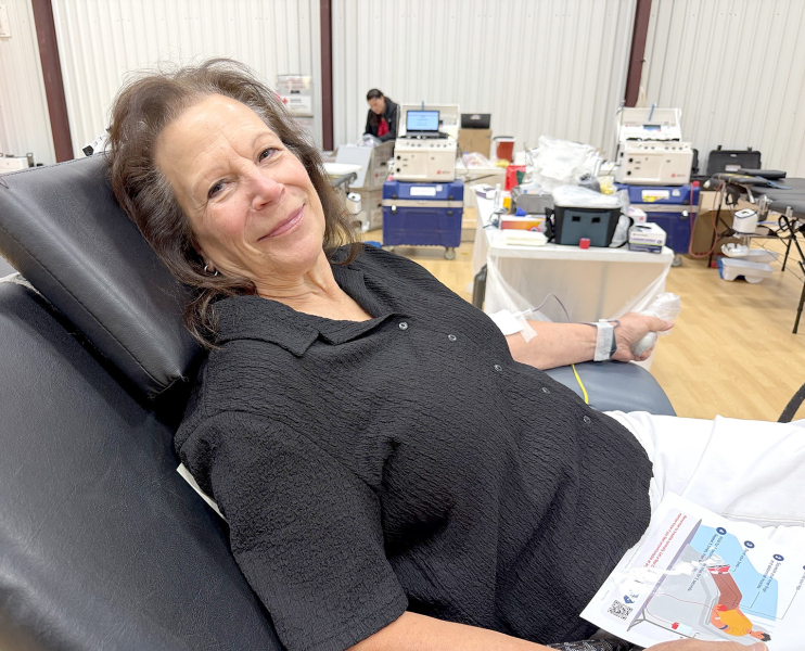 NANCY (VOTAPKA) DIACON, daughter of the late Dr.William Votapka, donates blood at the RCH Auxiliary Memorial Blood Drive held August 3 at the Plainville Christian Church Fellowship Hall. The event honored the first four physicians to serve Rooks County Health Center: Dr. Vale Page, Dr. A. M. Pederson, Dr. Harold Mauck, and Dr. William Votapka. (Photo Courtesy of Kathy Ramsey)