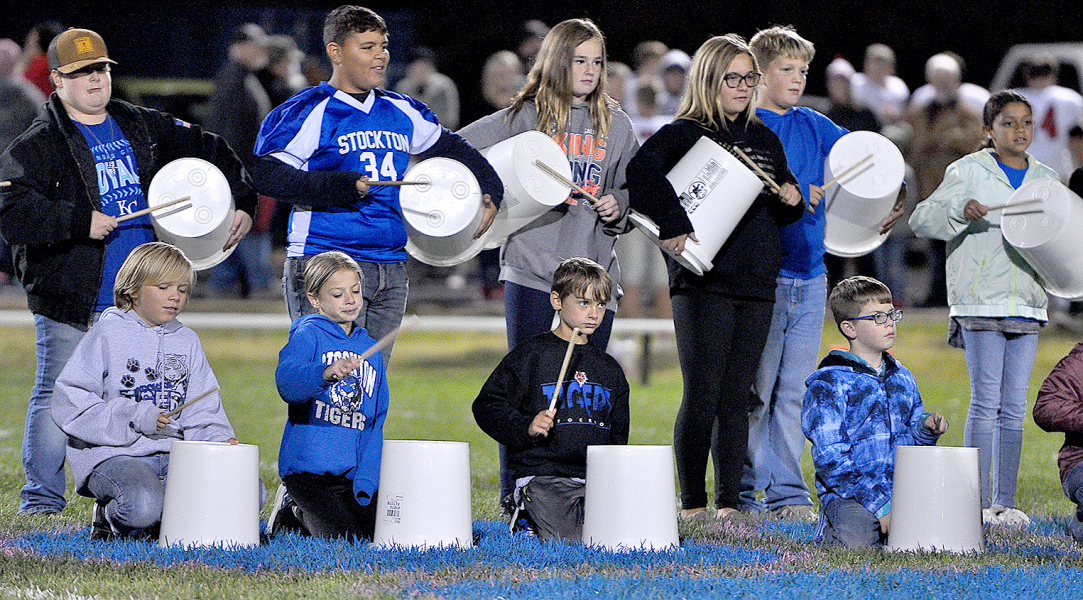 USING THEIR BUCKETS, several of the grade school students contributed to the Tiger Band's performance at halftime of Stockton's game against Decatur County.