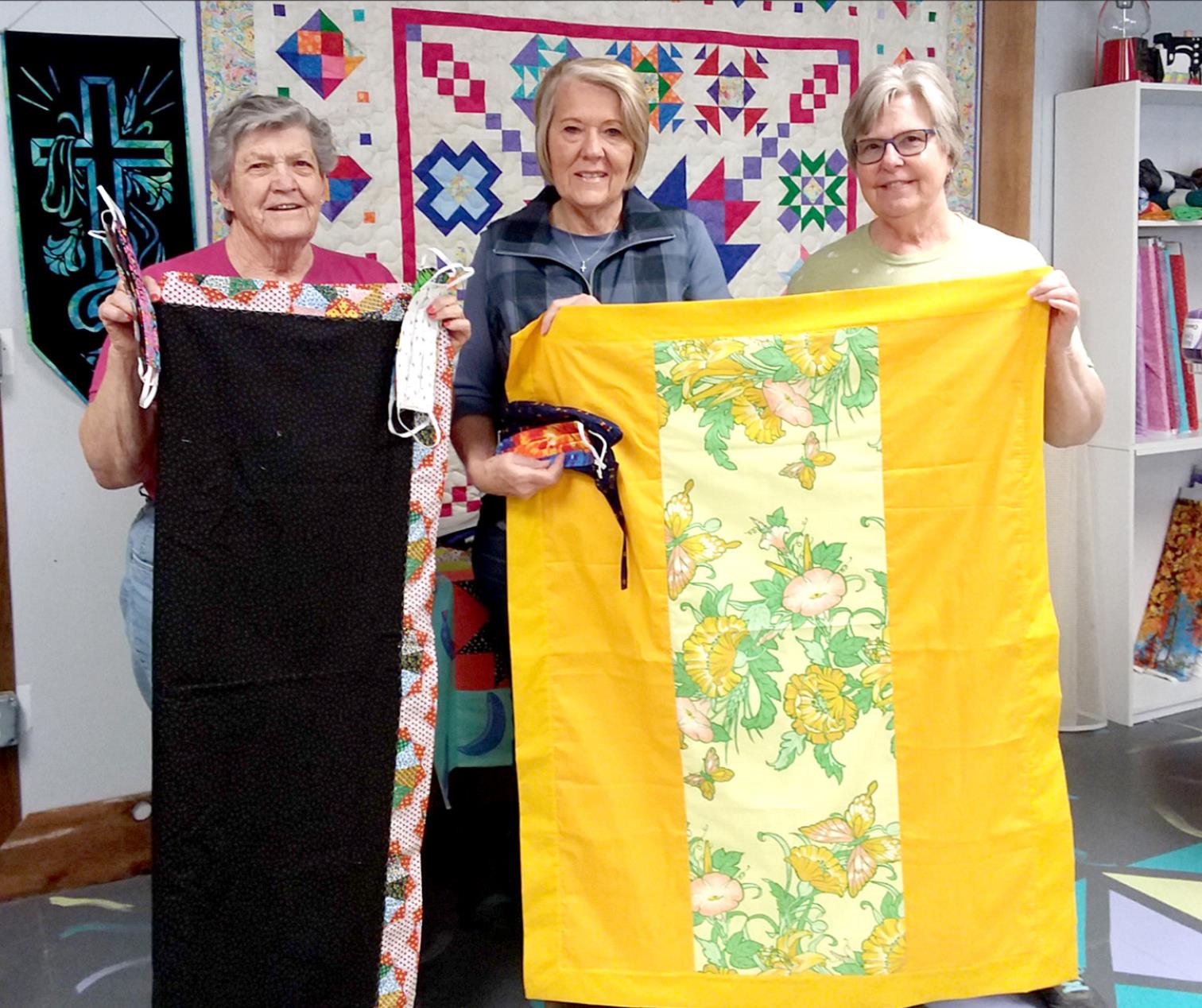 JUDY RUSS, JANIE LOWRY AND IDONA DUNCAN have been busy sewing masks and lap robes to send to family members, hospitals, and other community members during the COVID-19 pandemic.