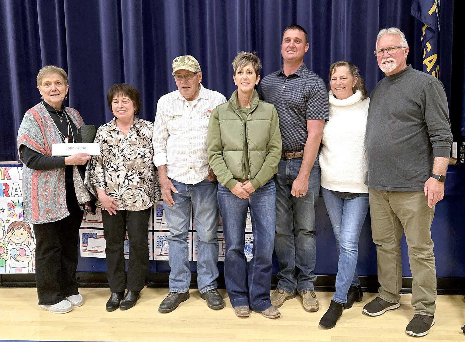CINDY NEWELL made seven of the Quilts of Valor presented at the Veterans Day program held at Stockton High School on Tuesday, November 11th. Pictured are Irma Newell, who accepted the quilt for her son, John; Cindy Newell; Ken Dreiling; Jill Jantz; Joel Laurin; Mary Jo Laurin; and Jack Laurin. This touching presentation was particularly special as Cindy is the aunt and Irma is the mother of siblings John, Jill, Joel, Mary Jo, and Jack.