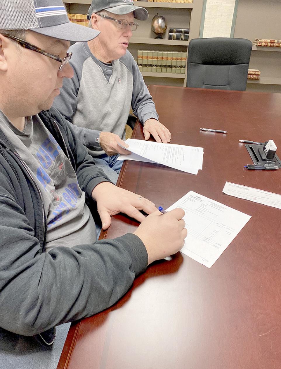 A Done Deal! PRESENT FORTHE SIGNING of the closing papers on the American Legion Building were Stockon Rodders President Dean Kester and treasurer Roger Roy, as well as secretary Libby Kester. Pictured are Dean Kester and Roger Roy signing the papers.