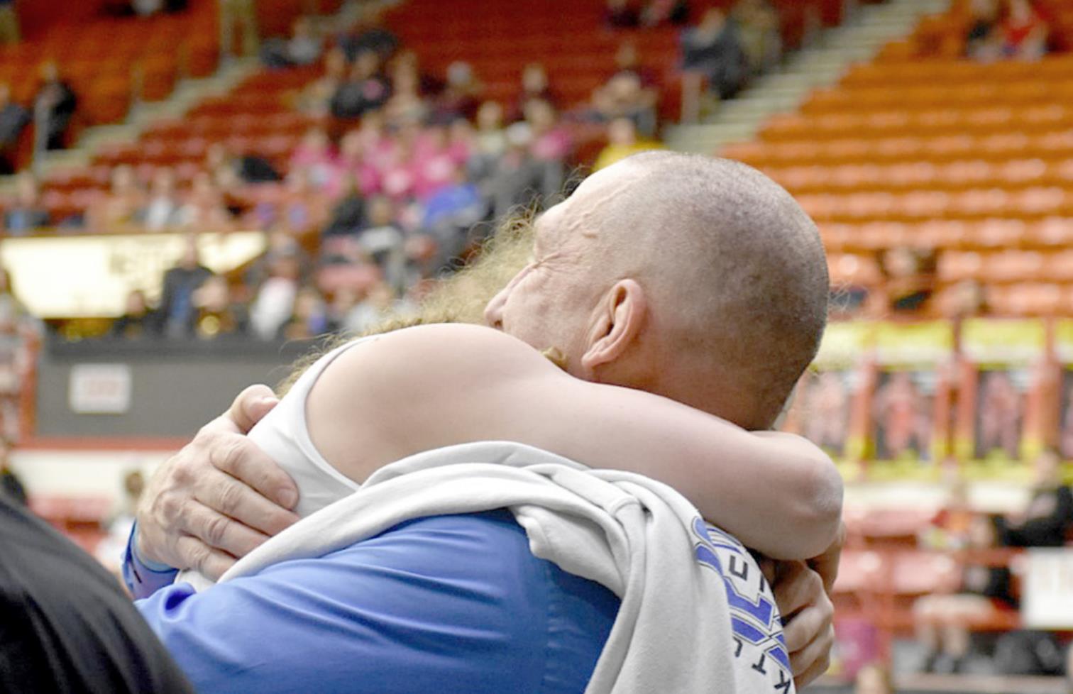HOW SWEET IT IS! Stockton freshman Ashlyn Hahn is congratulated by Coach Clint Bedore after winning her third-place match against Breanna Ross of Erie by a fall. Hahn wrestled in the 115-lb. division at the 4A-1A State Championship in Salina. (Photo courtesy of Bobbi Basart)