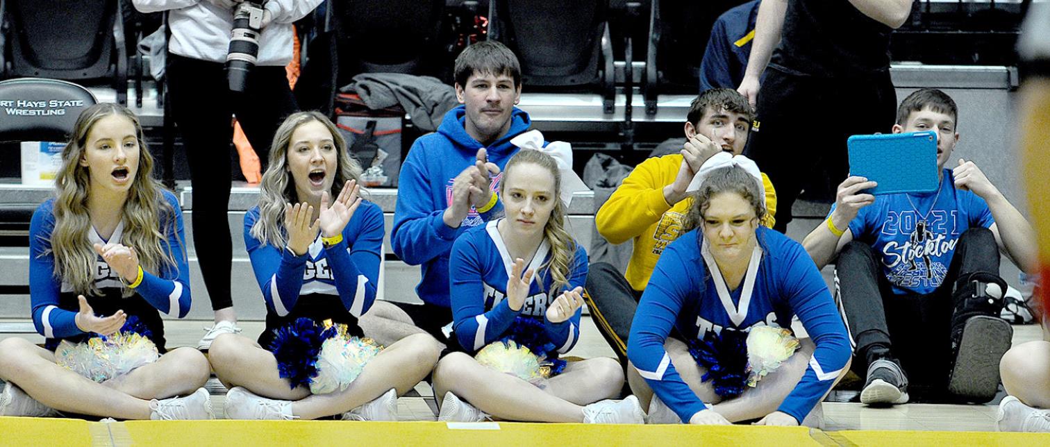 SHS CHEERLEADERS, as well as fellow wrestlers Rylan Basart, Justin Knoll and Camden Iwanski, cheer Emerson Lowry on to a win during state wrestling tournament action. Cheerleaders from left are: Ava Dix, Claire Plumer, Delany Snyder and Addie Struckhoff.