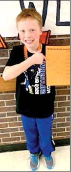 ZEKE BALTHAZOR proudly shows off his bracket after he was crowned champion in his weight class at the Ellis Open on Saturday, January 18th.