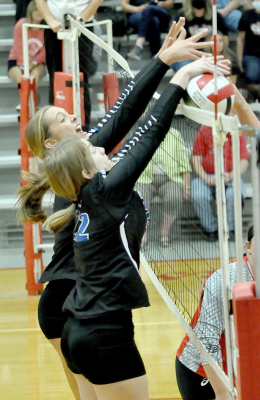 OLIVIA DIX (LEFT) AND ELIZABETH BUSONIC, score a point for the Stockton Lady Tigers following this block. The action took place during the volleyball match at Hill City last Tuesday.