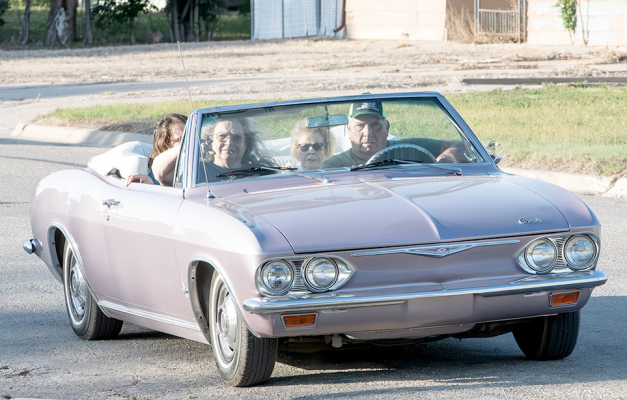 DURING LAST FRIDAY’S CRUISE NIGHT in Stockton, Doug, Kim, and Amanda French gave Betty Cadoret (second from right) a buzz around town in their evening orchid 1965 Chevrolet Corvair.