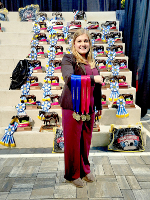 UNIVERSITY OF NEBRASKA-LINCOLN JUNIOR CALEIGH IWANSKI poses with her medals in Horse Judging at the All American Quarter Horse Congress in Columbus, Ohio. She placed first OVERALL in her division.