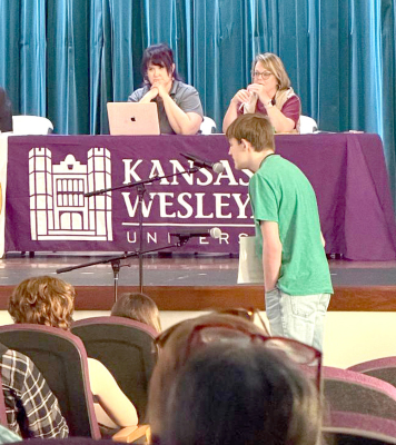 DURINGONEOFTHEEARLYROUNDS of the Sunflower State Spelling Bee, Veidyn Holmes took his turn at the microphone. Holmes, a student at Plainville Junior High, represented Rooks County at the Kansas Sunflower State Spelling Bee on Saturday, March 21st. He earned the title of Rooks County Spelling Bee Champion after winning that competition in February.