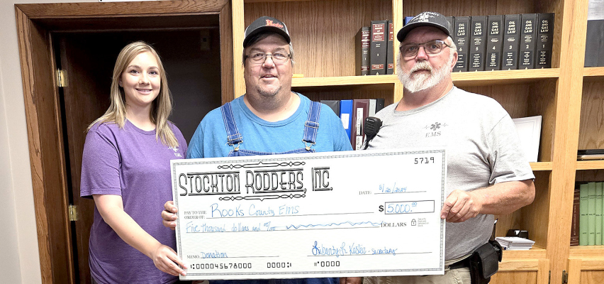 STOCKTON RODDERS,INC. donated a $5,000.00 check to the Rooks County EMS at the Stockton City Commission meeting on Tuesday, August 20th. Pictured are EMS Director Megan Niblock, Dean Kester representing the Rodders, and EMT Jim Prockish.