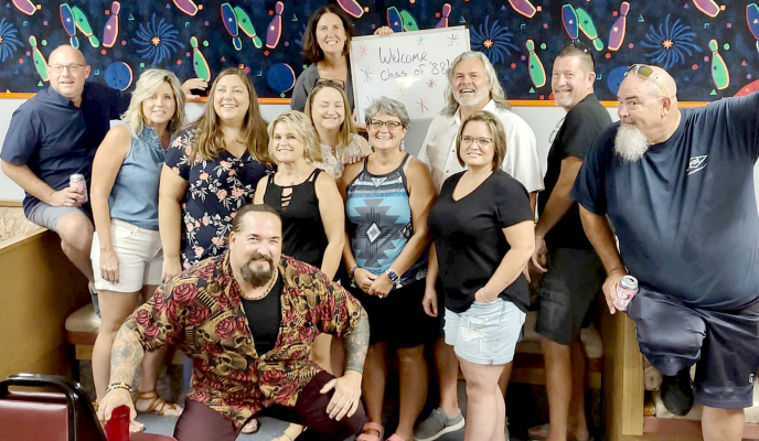 THE SHS CLASS OF 1988 held its 35th reunion the weekend before the Rooks County Fair. This is one of the many pictures taken. In this picture are Jason Creighton (kneeling); (from left) Lance Latham, Genell (Cramer) Albert, Jill Turnbull, Brenda (Roy) Newell, LeAnn (Hahn) Scott, Denise (Miller) Baumgart, Angela (Havlas) Kollman, Chris Hartzler, Tim Johnston, Kurt Oliva; and (holding sign) Niki McDowell. (Courtesy Photo)
