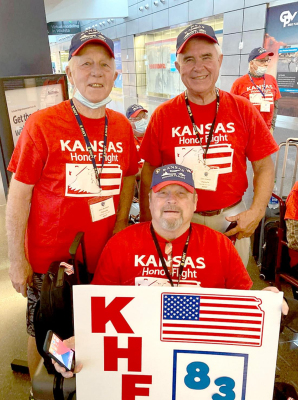 THESE THREE ROOKS COUNTY VETERANS were part of a group of 39 Kansas Veterans on Kansas Honor Flight #83 who enjoyed the trip of a lifetime to Washington, D.C. earlier this month. In front, holding sign, is Corky Hagan; and back row, from left: Jack Burton and Don Lowry.