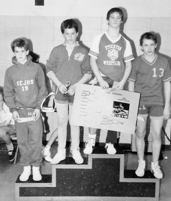COREY JOHNSTON, second from right, won the 115 lb championship at the 1989 MCEL Wrestling Tournament in Ellis. Corey won all of his matches during the year.