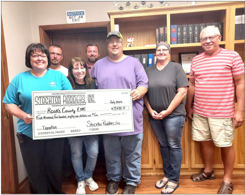 ROOKS COUNTY EMS was presented with a check from the Stockton Rodders, Inc. during the regular city commission meeting held on Tuesday, July 19th. Pictured are (first row, from left): Rooks County EMS Director Julie Cole, Stockton Rodders, Inc. members Libby and Dean Kester, mayor Reesa Brown, commissioner Bob Becker; (back row, from left) commissioners Adam Bryant and Nathan Glendening.