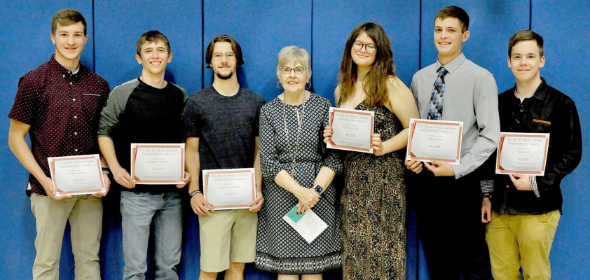 SHEILA LATHAM, center, gathered with the recipients of the Darrell and Sheila Latham Scholarship for Success following the SHS Awards Night held on May 6th. From left are: Deyton Bedore, Brayden Wallace, Leighton Colburn, Latham, Emil Benavides, Nolan Buss, and Isaac Reed.