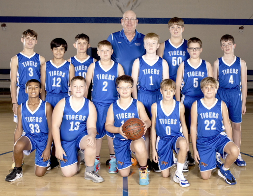 MEMBERS OF THE 2025-26 STOCKTON JUNIOR HIGH BOYS BASKETBALL TEAM were kneeling from left: Treyvonn Clark, Jack Morgan, Carter Martin, Henry Berkley, and Gabe Kuhlmann; and standing: Lane Muir, Jefferson Creighton, Kyler Hrabe, Grayson Mongeau, head coach Ray Niblock, Maverick Post, Hudson Muir, Brodye Odle, and Hudson Kriley. (Photo by Julie Kuhlmann Photography)