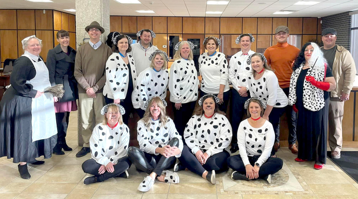 SOLUTIONS NORTH BANK went all out with a 101 Dalmatians theme this Halloween! Pictured are (front row) Dalmatians Jackie Spires, Shari Coffey, Caitlin Hammond, Carissa Brass; (back row) Nanny Amber Muir, Ginger Kriley and Jonathan Berkley as Anita and Roger Dearly, Dalmatians Linda Conyac, Travis Kleweno, Angie Johnston, Staci Ketelsen, Diane Voss, Brian Berkley, and Virginia Bice, Connor Haresnape as Jasper, Anita Conger as Cruella de Vil, and Chase Look as Horace Badun.