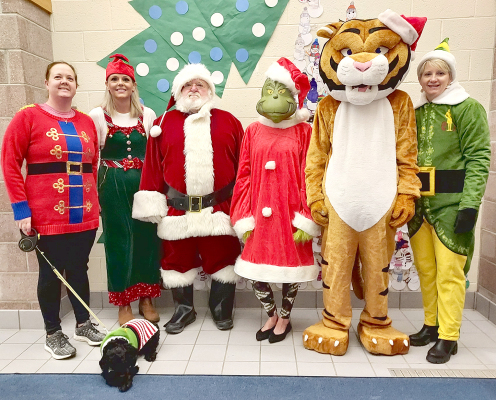 Alexa Rogers and Holly, Lindsay Cravens, Santa Claus, Sarah Armstrong, Troy Rogers, and Stacey Green took High Five Friday to a new level when they dressed up as Christmas characters on Friday, December 15th, to greet the boys and girls to start the school day.