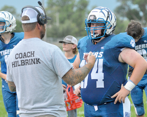 RYAN MONGEAU receives some instruction from Coach Spencer Hilbrink during at timeout in the Tigers’ game vs. Logan/Palco on September 2.