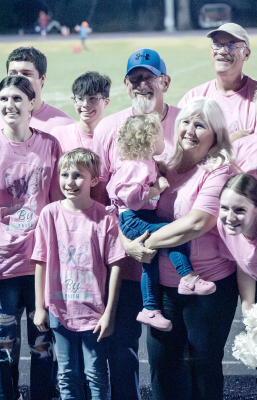 IT WAS PINK OUT NIGHT last Friday at Tiger Stadium. Bobbi Basart (holding her granddaughter), got together for a “team” picture with many of her family and friends who were wearing Breast Cancer Awareness t-shirts in her honor. This shows just a fraction of those gathered on the track. Basart is the cheer sponsor for Stockton High School. The SHS KAYS Club held a fundraiser that night for the Rooks County Cancer Council.