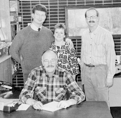 IN DECEMBER 1989, it had been announced that Plainville was getting another doctor. Pictured are hospital administrator Jim Turnbull (seated), physician recruitment chairman Dave Comeau (right) and Dr. and Mrs. Mark Kelly.