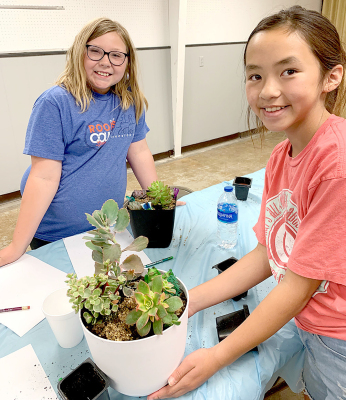 OLIVIA LUNA AND HARTLEY TAKAISHI enjoyed digging in the dirt at the Theme Garden Day Camp held at the Harding Hall 4-H building.