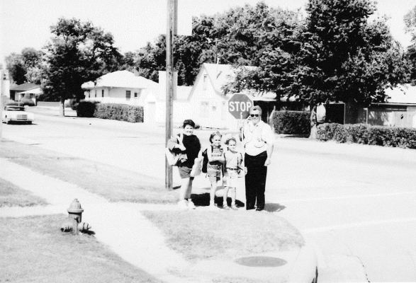 READY FORTHE 1994-1995 school year are Heather Kriley, Sadie Laska, and MaKenzie Green waiting for Chuck Williams to safely walk them across the highway.
