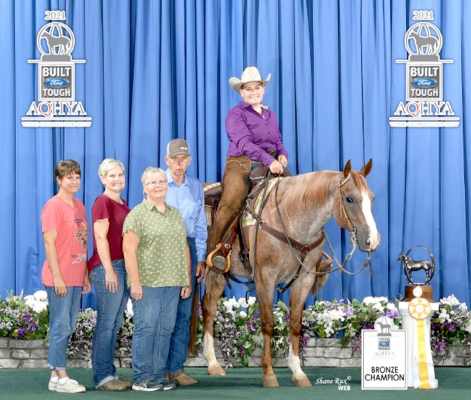 POSING FOR A PICTURE after Caleigh placed third in the world at the Kansas Quarter Horse Youth Association in Level 3 Ranch Trail Division are (from left): Bobbie Hinds of Lawrence (AQHYA advisor), Caleigh’s mom Jessica Iwanski, Rosanne Cole and Craig Cole of Downs (Cole Training Stables owners), Caleigh and Husker.