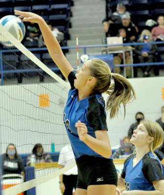 LADY TIGER JUNIOR OLIVIA DIX, with teammate Elizabeth Busonic looking on, scores a point in Stockton’s match against Smith Center held in Tiger Gymnasium on September 8.