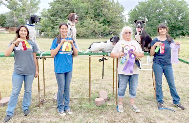 PICTURED are Jayana Creighton with Rocky, Jalia Creighton with Sam, Kathy Creighton with KC, and Jazlynn Creighton with Elly at the Dog Agility Contest held on Saturday, July 20th.