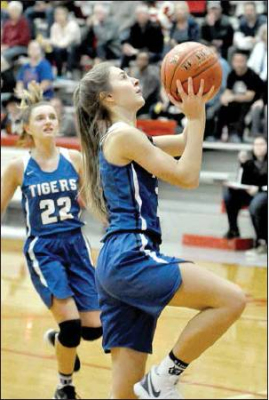 WITH TATUM HAMILTON trailing her, Shae Griffin goes in for a layup, scoring two of her 17 points in the game against Hill City.
