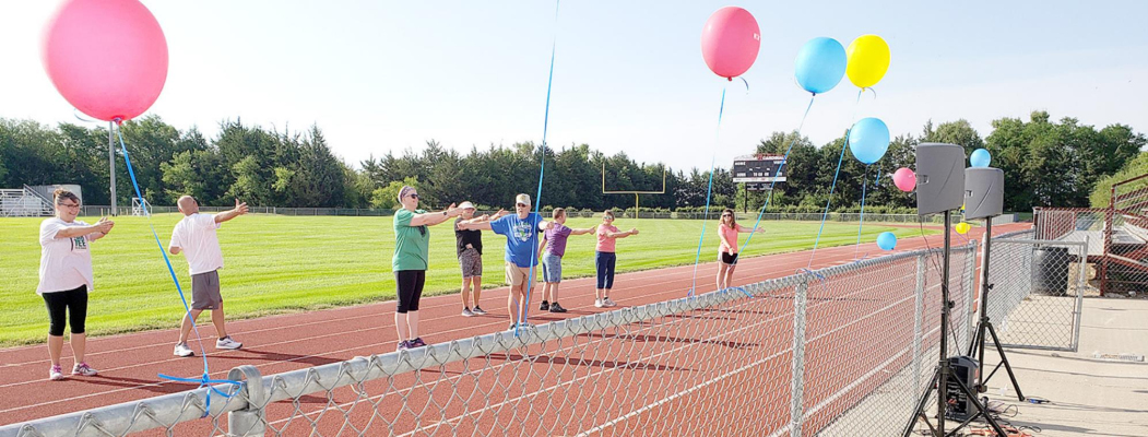 THE FIRST WALK WITH A DOC was held Saturday, July 10th, at the Plainville Cardinal Football Field, led by Dr. Jen Brull. A total of 13 people participated in the event. Dr. Jen Brull can be seen leading a stretching session following the walk before the group enjoyed snacks of fruit and orange juice popsicles.