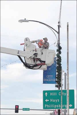 THE STOCKTON CITY EMPLOYEES took advantage of the lovely fall day when they put up the Christmas decorations on Main Street on Tuesday, November 14th. Corey Carlson is shown in the bucket truck stringing the lights.