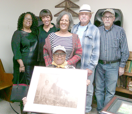ANGELA BATES was the guest speaker at the Rooks County Historical Society and Museum’s annual meeting on Sunday,April 27th.The 1877 EllisTrail production was shown with descendants of the first settlers of Nicodemus present. Pictured are (sitting): Angela Bates holding a photo of the Charles and Emma Williams family; (back row) Johnella Holmes, Marilyn Sayers, Cheryl Bates Jones, Leroy Walz (Ellis landowner), and Darris Worcester (artist, Hill City).
