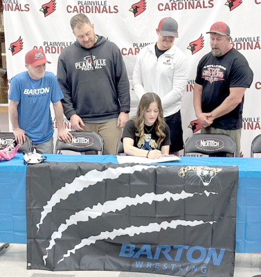 PLAINVILLE HIGH SCHOOL SENIOR KAELEIGH KLEIN officially signed her letter of intent last Wednesday to continue her wrestling career with the Cougars at Barton County Community College. Among those joining her for the signing were her father, Justin Klein, along with coaches Garrett Smith, Brandon Rohr and Ryan Becker.