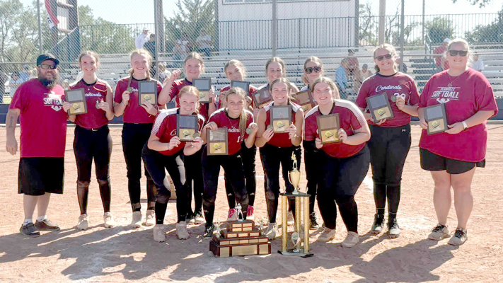 THE 2025 K-18 SOFTBALL CHAMPION PLAINVILLE CARDINALS display the hardware they garnered following their third consecutive state championship. Pictured front row, from left are: Baileigh Balthazor, Kaleigh Kline, Emma Fuzzell, and Rylan Weltmer; and back row from left: Coach Ryan Weltmer, Lizzie Deutscher, Leigha Balthazor, Hudsyn Bethel, Hayden Hilgers, Maddy Dintino, Kali Witt, Ellie Plante and assistant coach Jamie Stahl.