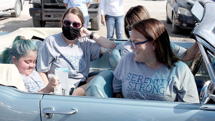 LAST FRIDAY, OCT. 9, WAS “SERENITY DAY” IN STOCKTON, as Serenity Carpenter was taken on a Scavenger Hunt to find gifts provided by the Make-A-Wish Foundation. Serenity wished for technology that will keep her connected with friends and family during her six-month stay in Kansas City. Shown with Serenity are her mother, Jordan Carpenter, and Wish Granters, Kacy Becker (back seat) and Addie Foster.