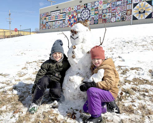 RHETT AND ALENA RIFFEL, children of JD and Ginger Riffel of Stockton, share smiles with their snowman Tom Mato and an adorable snow baby after a fun-filled morning of sledding at Stockton City Park on Saturday, February 21. (Courtesy Photo)