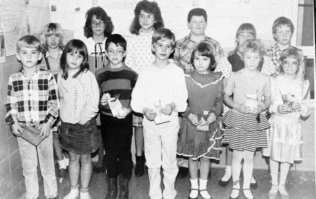 ONE GROUP OF HONORABLE MENTION WINNERS in the 1989 Rooks County Soil Conservation Poster Contest who attended the annual meeting were (front row, from left): Justin Brin, Kimberly Berland, Marshall Neinstedt, John Schamber, Brandy Williams, Melody Hollern, Emily Dinkel (back row) Nichole Thayer, Lisa Kay Meyers, Erin Schambers, Preston Gosselin, Sara McReynolds, and Brandon Deutscher.