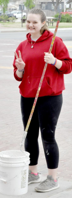 SAVY GRAY helps paint the lines on Main Street during PRIDE Day.